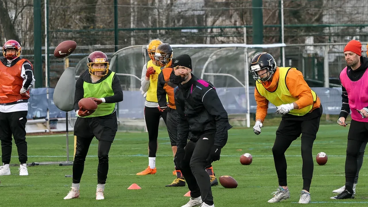 Adult academy players doing a passing drill with a coach